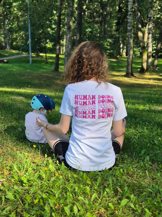 Unisex slogan tee with pastel mantra on the back: Human Being